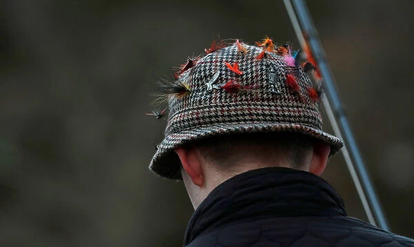 Lures are seen on an anglers hat on the opening day of the salmon fishing season on the