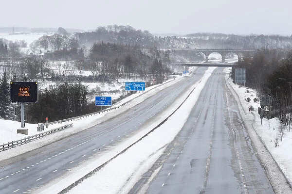 The M80 motorway is completely empty after being closed to clear vehicles stranded by bad