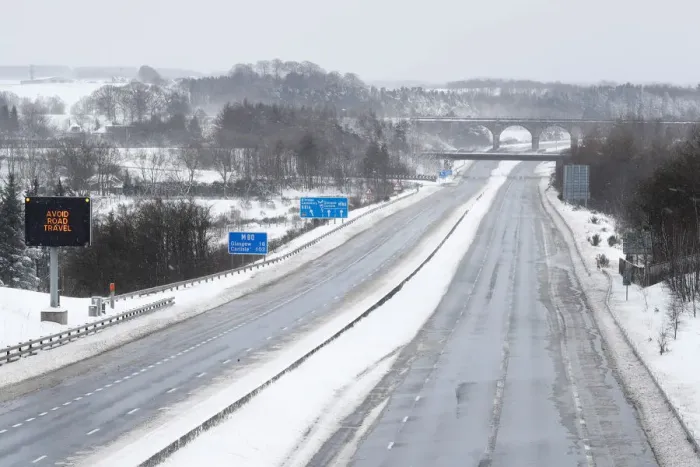Framed Print : The M80 motorway is completely empty after being closed to clear vehicles stranded by bad Framed Print : The M80 motorway is completely empty after being closed to clear vehicles stranded by bad
