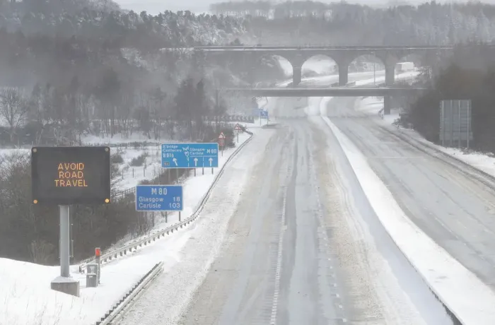 Framed Print : The M80 motorway is completely empty after being closed to clear vehicles stranded by bad Framed Print : The M80 motorway is completely empty after being closed to clear vehicles stranded by bad
