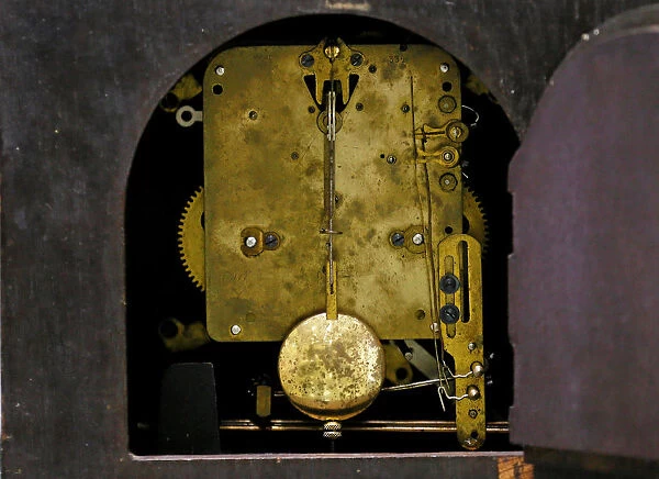 The machine of a classic wooden clock is seen at a workshop in Colombo