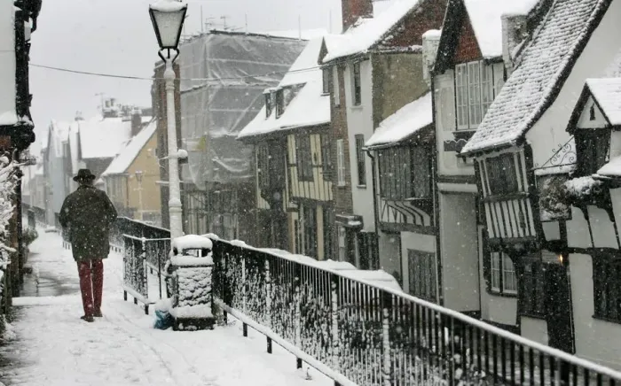 Framed Print : Man braves wintry conditions in Old Hastings in Sussex southern England Framed Print : Man braves wintry conditions in Old Hastings in Sussex southern England