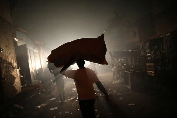 A man carries a sack out of a fire at a market in Port-au-Prince