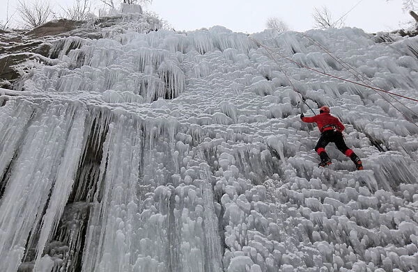 A man climbs an artificial wall of ice in the city of Liberec
