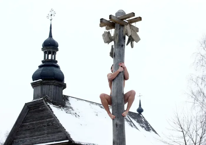 Framed Print : Man climbs up a wooden pole to get a prize during celebration of Maslenitsa Framed Print : Man climbs up a wooden pole to get a prize during celebration of Maslenitsa