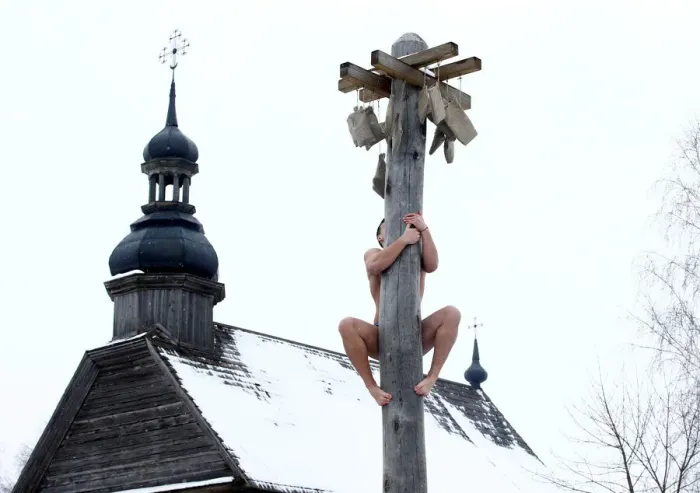 Framed Print : Man climbs up a wooden pole to get a prize during celebration of Maslenitsa Framed Print : Man climbs up a wooden pole to get a prize during celebration of Maslenitsa