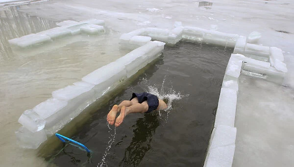 A man dives into the icy waters of a lake during Orthodox Epiphany celebrations in Minsk