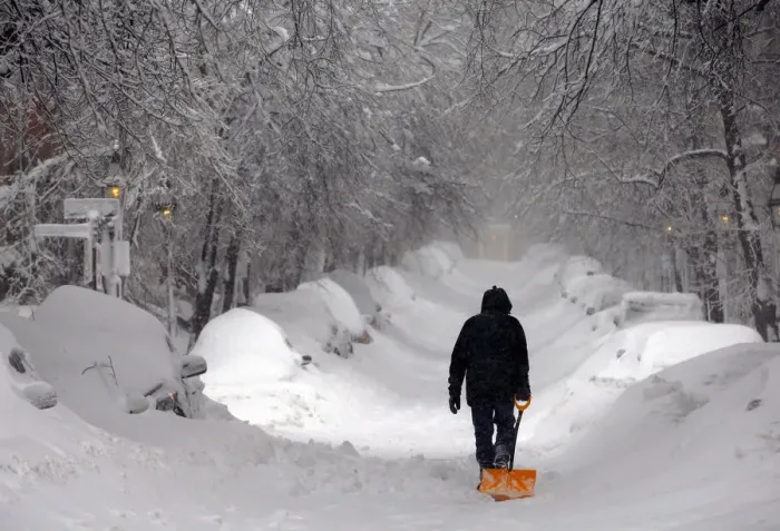 Framed Print : A man drags a shovel up Beacon Hill during a severe winter snow storm in Boston