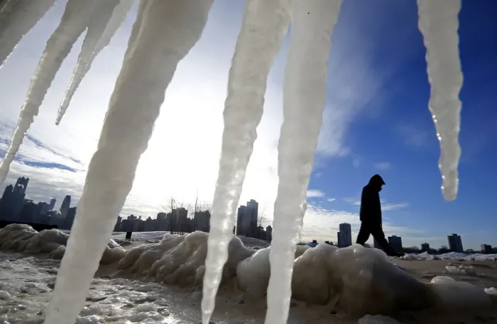 Framed Print : Man is framed by icicles as he walks along a beach in Chicago Framed Print : Man is framed by icicles as he walks along a beach in Chicago