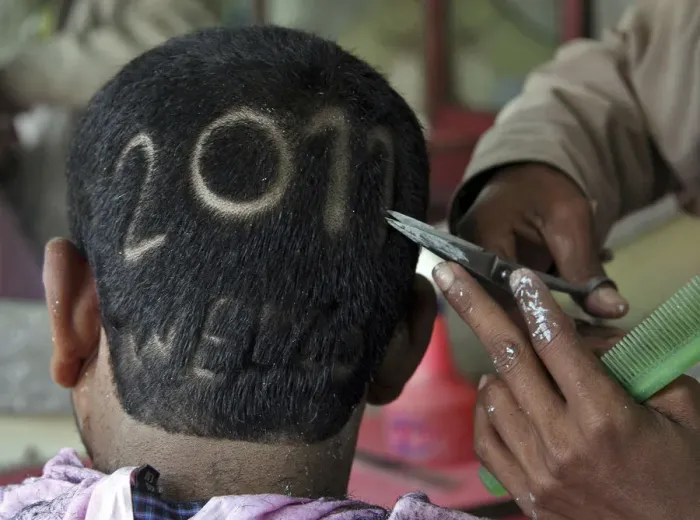 Framed Print : A man gets a haircut depicting 2011 to welcome the new year at a barbershop in