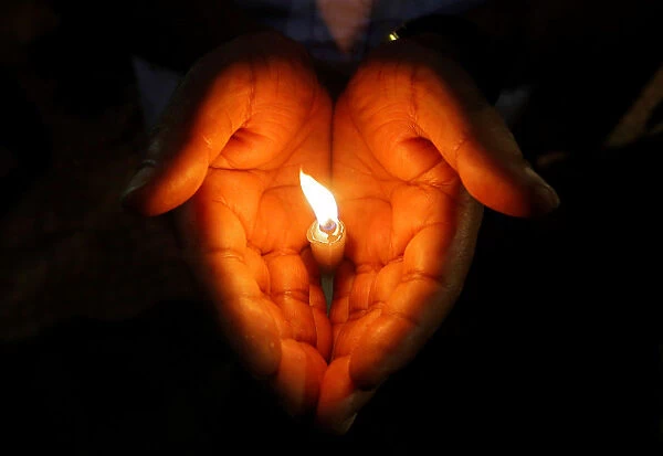 A man holds a candle during a vigil to show solidarity with the victims of Sri Lanka s