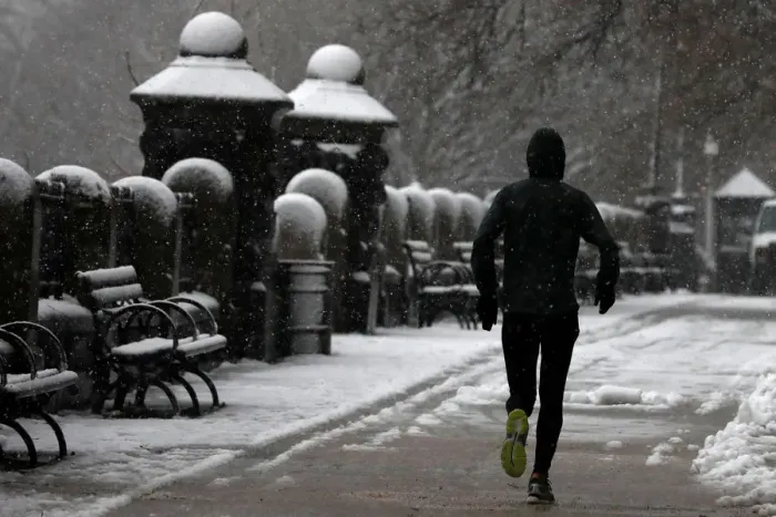 Framed Print : A man jogs during a snowstorm in upper Manhattan in New York City Framed Print : A man jogs during a snowstorm in upper Manhattan in New York City