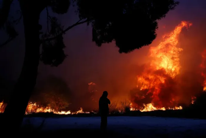 Framed Print : A man looks at the flames as a wildfire burns in the town of Rafina Framed Print : A man looks at the flames as a wildfire burns in the town of Rafina