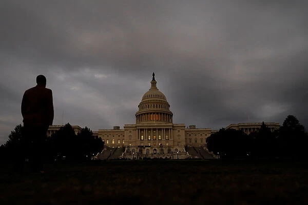 A man looks at the U. S. Capitol Building in Washington