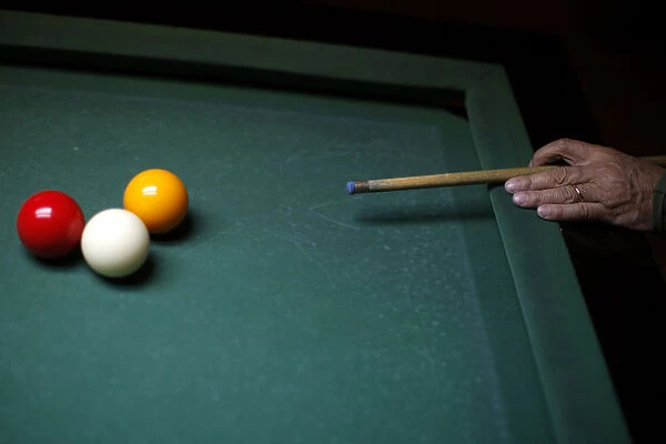 Man plays billiards at a social centre in Ronda