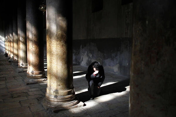 A man prays inside the Church of the Nativity in West Bank town of Bethlehem