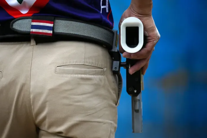 Framed Print : A man prepares to shoot during a practice session at a shooting range in Bangkok Framed Print : A man prepares to shoot during a practice session at a shooting range in Bangkok