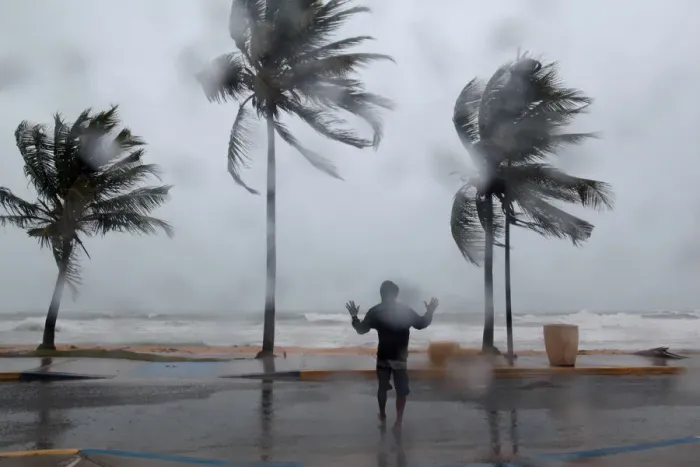Framed Print : A man reacts in the winds and rain in Luquillo as Hurricane Irma slammed across islands