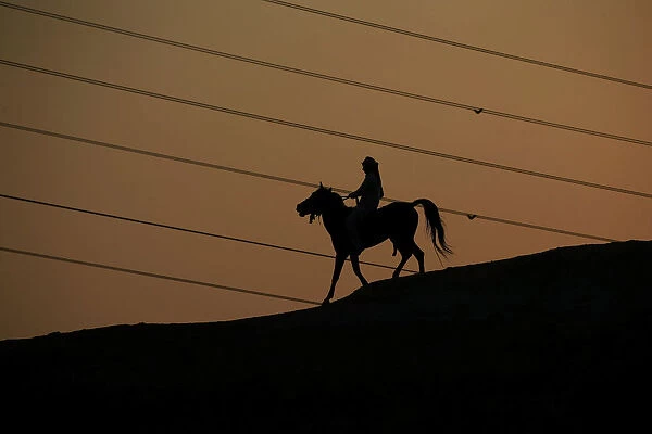 A man rides a horse in the holy Shi ite city of Najaf
