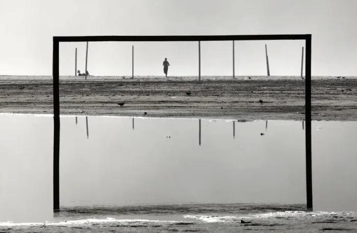 Framed Print : A man runs on Copacabana beach after heavy rains in Rio de Janeiro