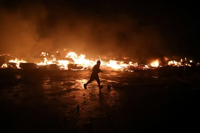 Framed Print : A man runs next to fire at a market in Port-au-Prince Framed Print : A man runs next to fire at a market in Port-au-Prince