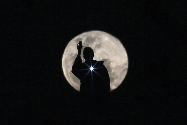 Man is seen photographing the full moon in Brasilia