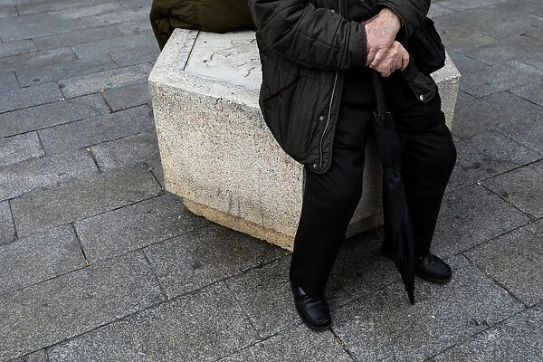 A man sits on the street in central Madrid
