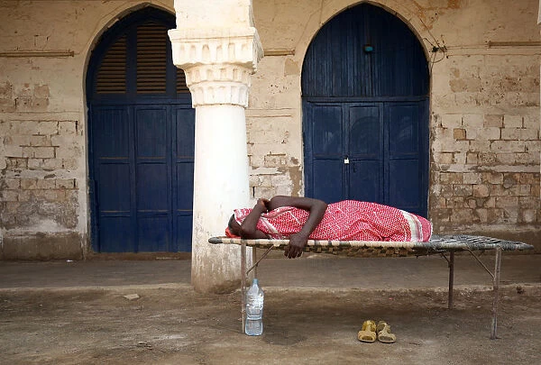 A man sleeps outdoors in the port city of Massawa