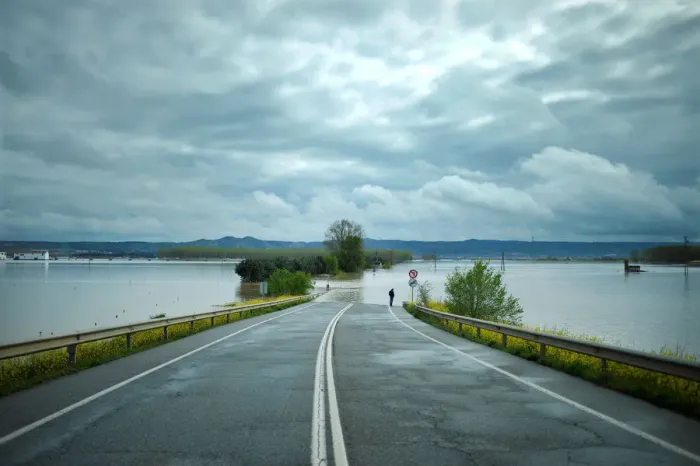 Framed Print : A man stands on a road flooded by waters from the River Ebro Framed Print : A man stands on a road flooded by waters from the River Ebro