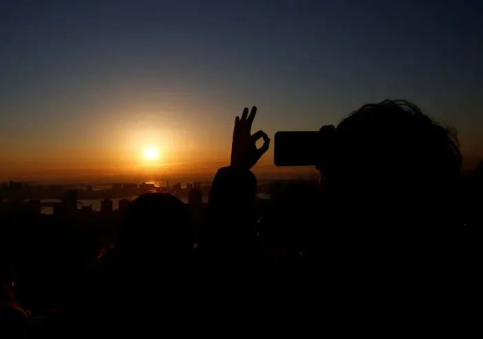 Framed Print : A man takes picture of the first sunrise on New Years Day at Roppongi Hills observation Framed Print : A man takes picture of the first sunrise on New Years Day at Roppongi Hills observation