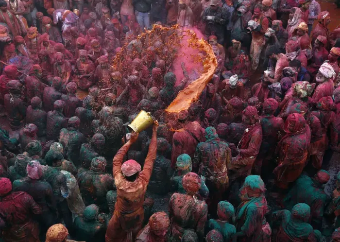 Framed Print : A man throws coloured water as he celebrates Lathmar Holi at Nandgaon Framed Print : A man throws coloured water as he celebrates Lathmar Holi at Nandgaon