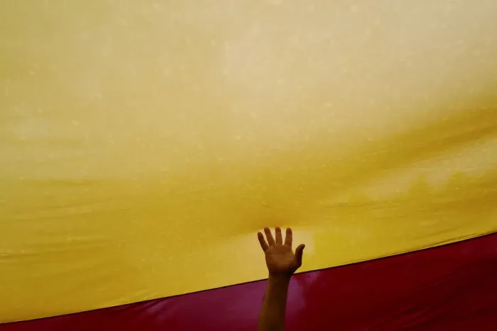 Framed Print : A man touches a Spanish flag during a demonstration in favour of a unified Spain a day Framed Print : A man touches a Spanish flag during a demonstration in favour of a unified Spain a day