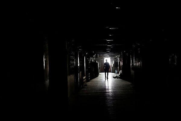 A man walks in a building during power outage in Karachi
