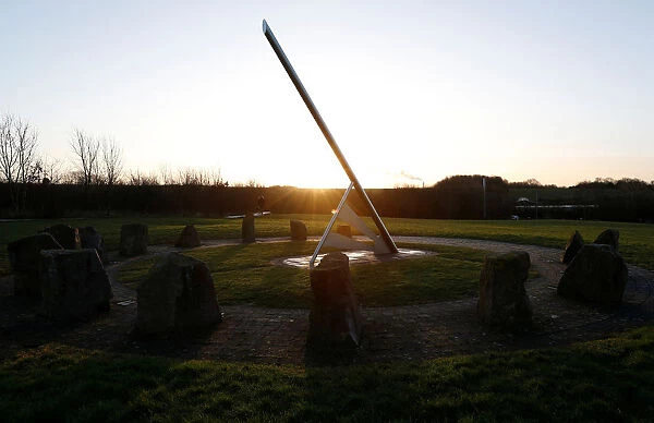 A man walks his dog past the Millennium Sundial in Barrow upon Soar