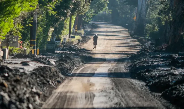 Framed Print : A man walks down East Valley Road after a mudslide in Montecito, California Framed Print : A man walks down East Valley Road after a mudslide in Montecito, California