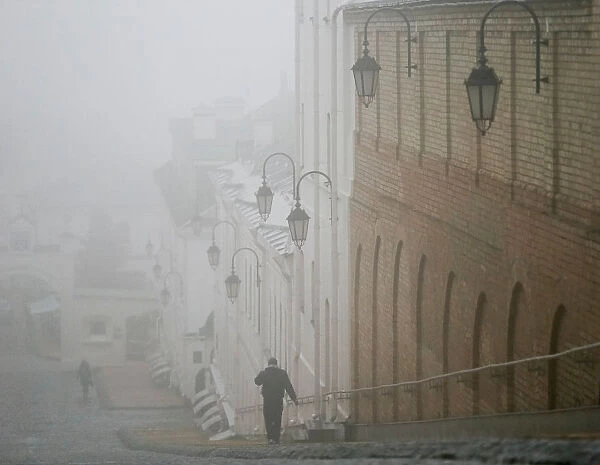 A man walks in fog in the territory of the Kiev Pechersk Lavra monastery in Kiev