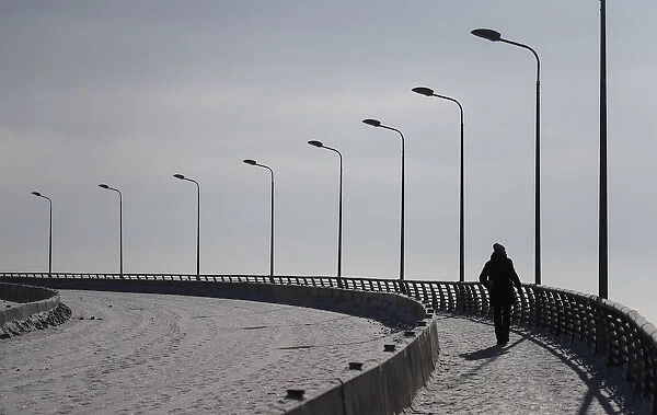 A man walks on the footpath on the outskirts of St. Petersburg