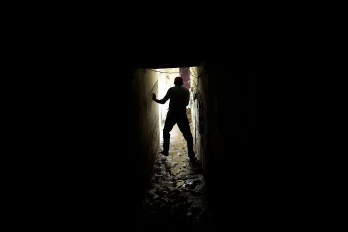 Framed Print : A man walks on mud inside his house after a flood in the low-income neighborhood of Framed Print : A man walks on mud inside his house after a flood in the low-income neighborhood of