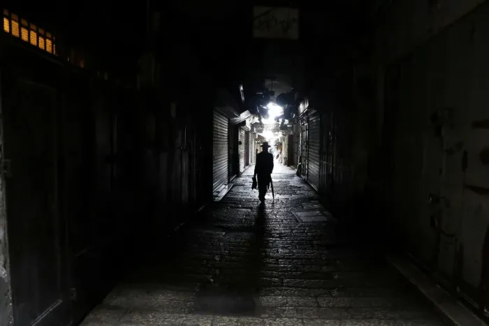 Framed Print : A man walks past closed shops as Palestinian political parties call for a general strike Framed Print : A man walks past closed shops as Palestinian political parties call for a general strike