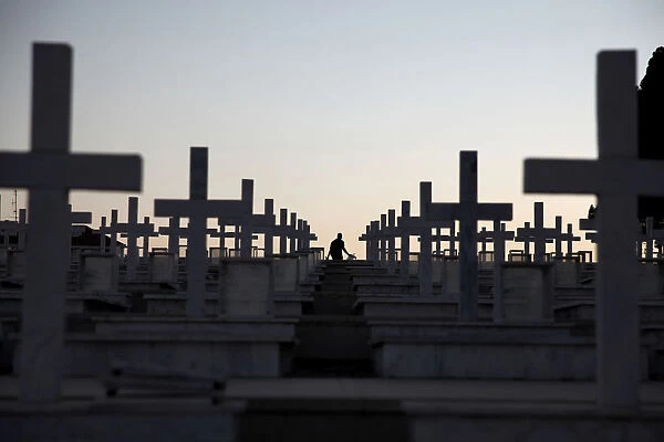 A man walks past the graves of soldiers killed in the 1974 Turkish invasion of Cyprus at