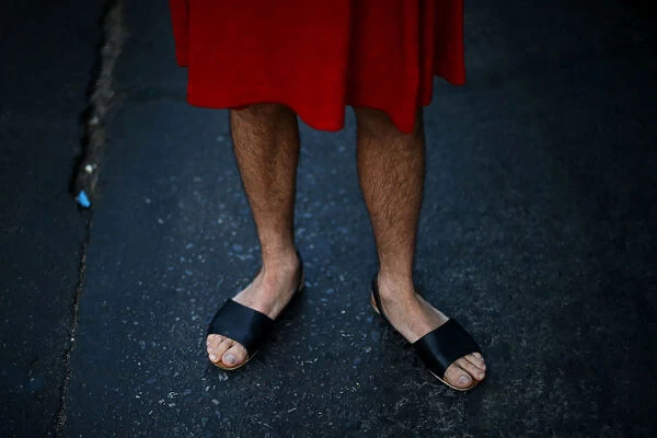 A man wears a dress as he attends a march to mark International Womens Day in Santiago