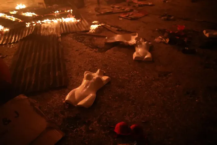 Framed Print : Mannequins lie on the ground during fire at a market in Port-au-Prince