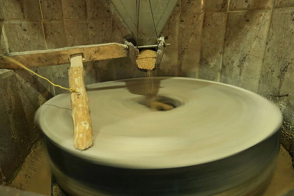 A manual wheel for grinding sesame, which operates by water