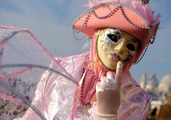 A masked reveller poses during the Venice Carnival