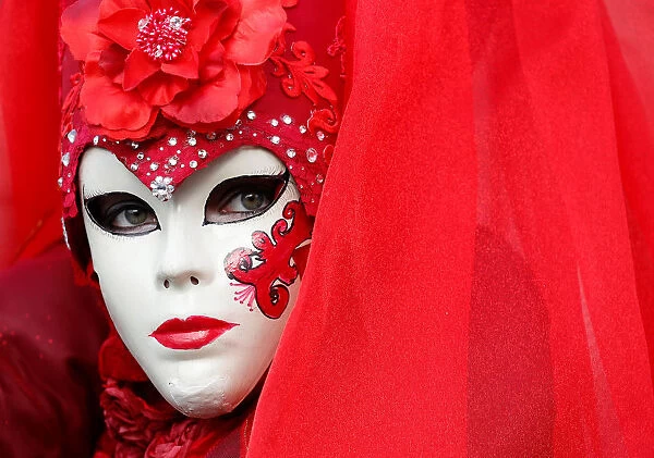 A masked reveller poses during the Venice Carnival in Venice