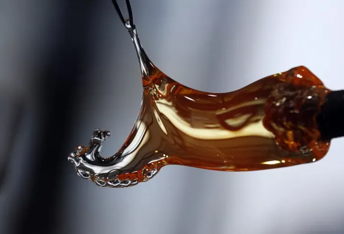 Framed Print : Master glassmaker uses tweezers to create a handmade horse glass at Royal Crystal Factory