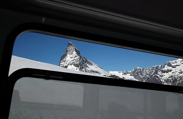 The Matterhorn mountain is pictured through a train window in Zermatt