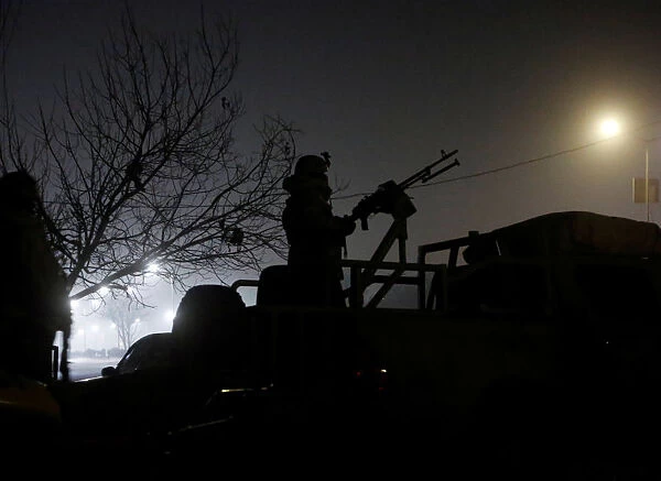 A member of the Afghan security forces keeps watch near the site of an attack on the