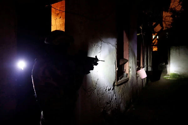 A member of Turkish police special forces takes part in a drug raid in Istanbul