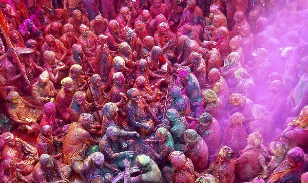 Men daubed in colours celebrate Lathmar Holi at Nandgaon